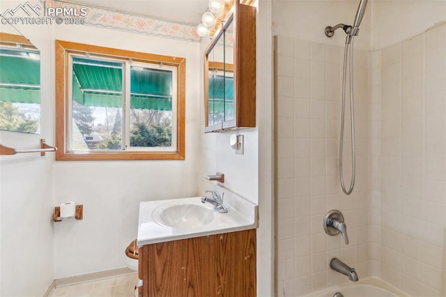 bathroom featuring tile patterned flooring, vanity, baseboards, and shower / bathtub combination