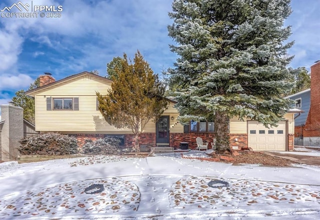 view of front of home featuring a garage, concrete driveway, brick siding, and a chimney