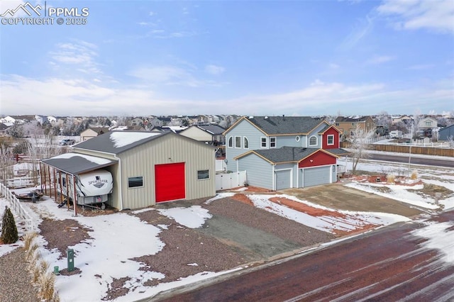 view of front of property with a garage, fence, and a residential view