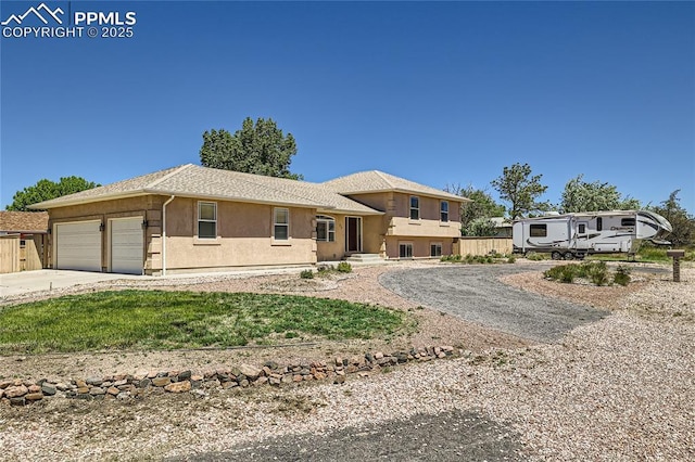 view of front of property featuring a garage, concrete driveway, and stucco siding