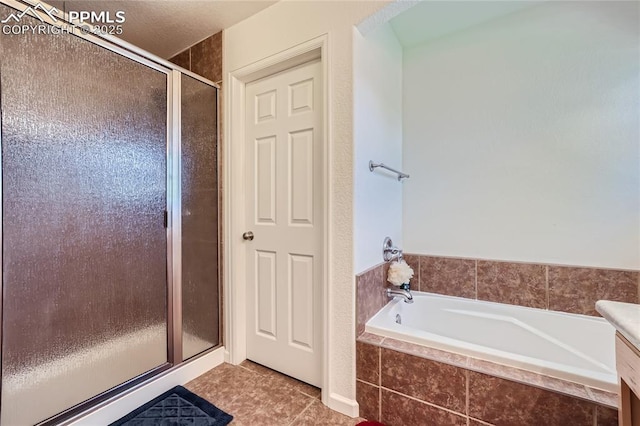 bathroom with a stall shower, a garden tub, vanity, and tile patterned floors