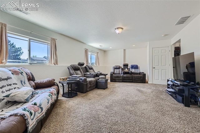 living room featuring carpet floors, visible vents, and a textured ceiling