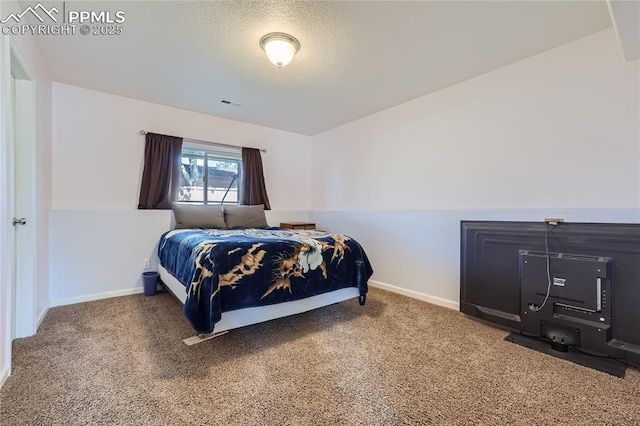 carpeted bedroom with visible vents, a textured ceiling, and baseboards