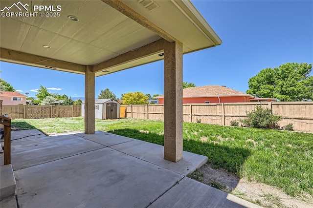 view of patio / terrace with a storage shed, an outbuilding, a fenced backyard, and visible vents