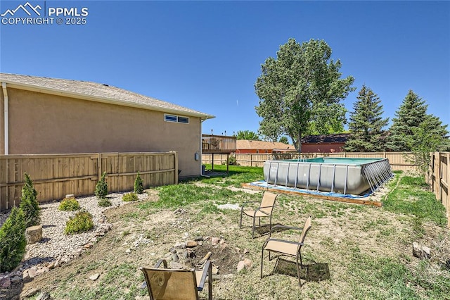 view of yard with a fenced in pool and a fenced backyard