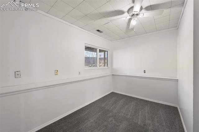 spare room with ceiling fan, dark carpet, and baseboards