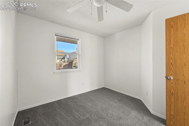 carpeted spare room featuring a textured ceiling, ceiling fan, visible vents, and baseboards