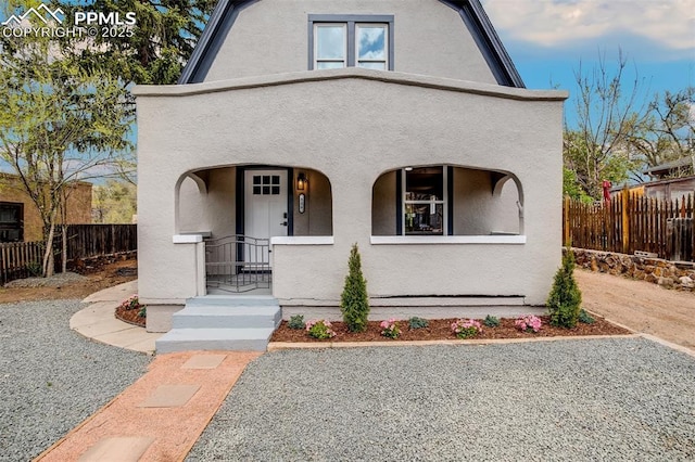 view of front of home featuring a fenced front yard and stucco siding