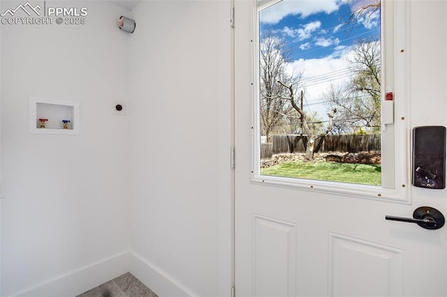 doorway featuring baseboards