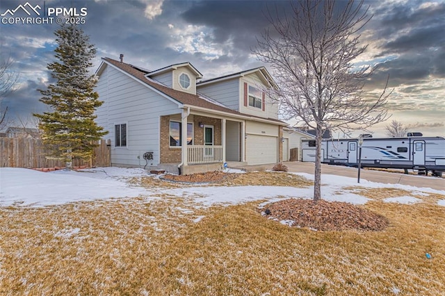 view of front of house with brick siding, covered porch, concrete driveway, an attached garage, and fence