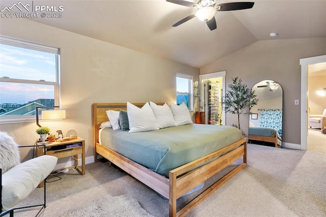 bedroom featuring light carpet, multiple windows, and vaulted ceiling