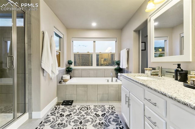 bathroom featuring a bath, a stall shower, vanity, and tile patterned floors