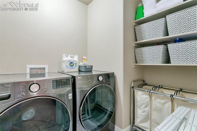 laundry room featuring washing machine and dryer and laundry area