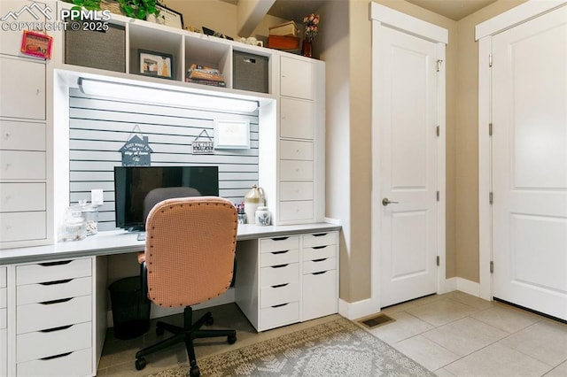 office with visible vents, baseboards, and light tile patterned floors