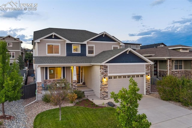 craftsman house featuring a shingled roof, concrete driveway, an attached garage, fence, and a front lawn