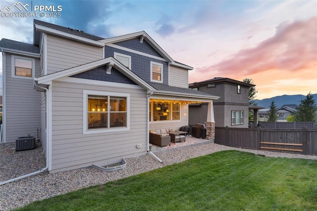 back of property with a patio, cooling unit, fence, an outdoor living space, and a lawn