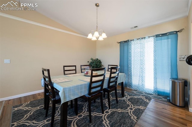 dining space featuring visible vents, an inviting chandelier, dark wood-type flooring, vaulted ceiling, and baseboards