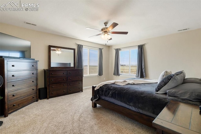 bedroom with light carpet, baseboards, visible vents, and a ceiling fan