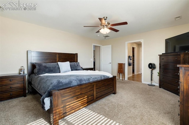 bedroom with a ceiling fan, light colored carpet, visible vents, and baseboards