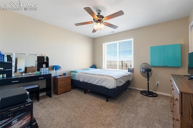 bedroom featuring light carpet, baseboards, and a ceiling fan