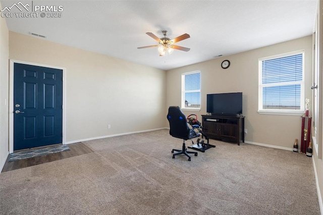 unfurnished office with baseboards, visible vents, ceiling fan, and carpet flooring