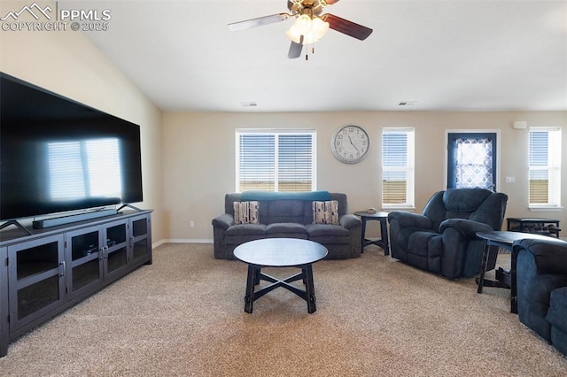 living room featuring baseboards, a ceiling fan, visible vents, and light colored carpet