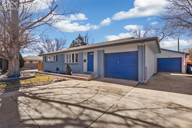 ranch-style home with a garage and driveway