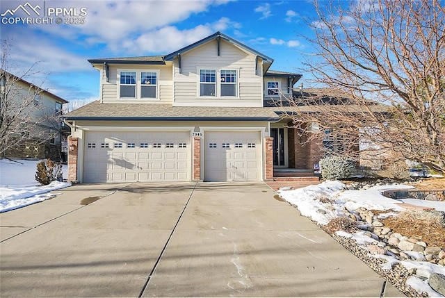 traditional-style home featuring a garage, concrete driveway, and brick siding