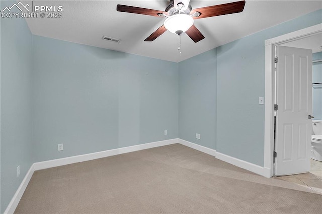 unfurnished room with light carpet, baseboards, visible vents, and ceiling fan