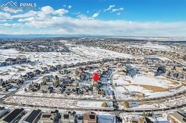 snowy aerial view featuring a residential view