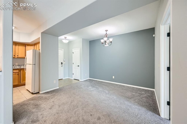 empty room featuring light carpet, baseboards, a chandelier, and light tile patterned flooring