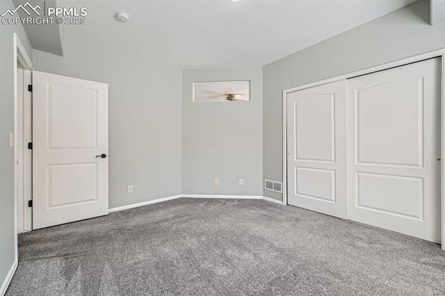 unfurnished bedroom featuring a closet, carpet, visible vents, and baseboards