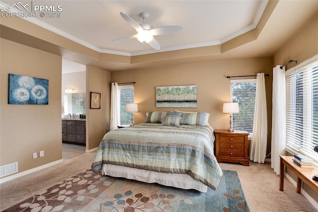 bedroom with multiple windows, a raised ceiling, and visible vents