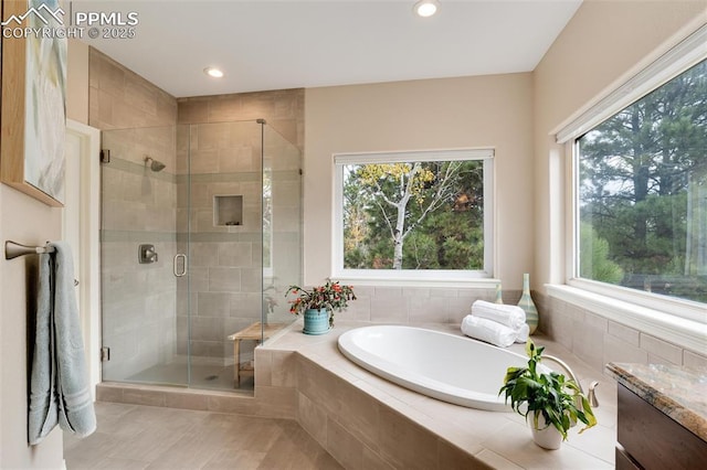 bathroom with recessed lighting, a shower stall, and a bath