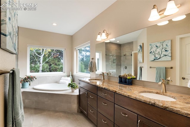 full bathroom featuring a garden tub, a sink, a shower stall, and double vanity