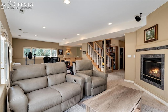 living room featuring light carpet, stairway, a fireplace, and recessed lighting