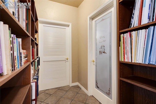 interior space with tile patterned flooring and baseboards