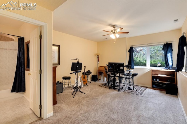 carpeted office space featuring tile patterned flooring, visible vents, and a ceiling fan