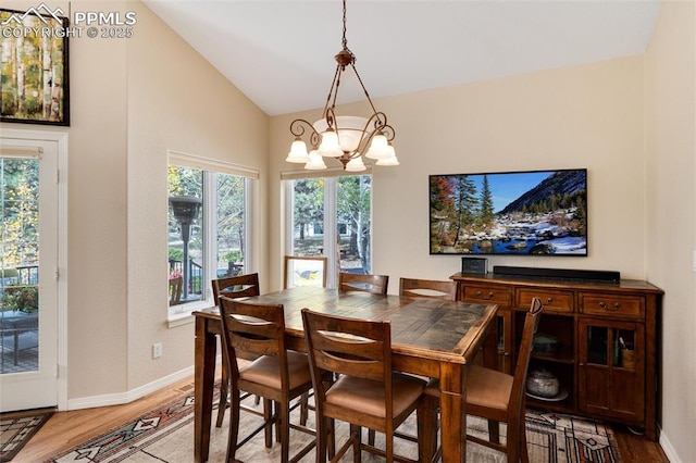 dining area with lofted ceiling, plenty of natural light, and light wood-style flooring