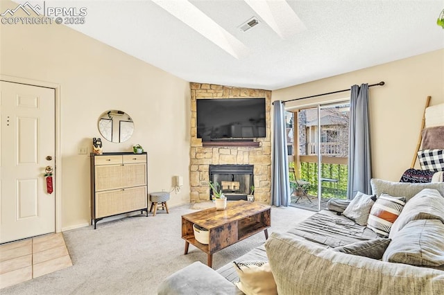 carpeted living room with a fireplace, vaulted ceiling, and a textured ceiling