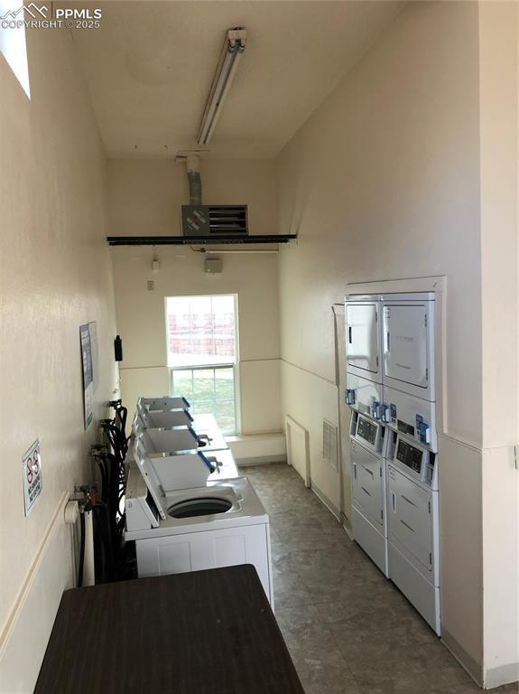 community laundry room with stacked washing maching and dryer