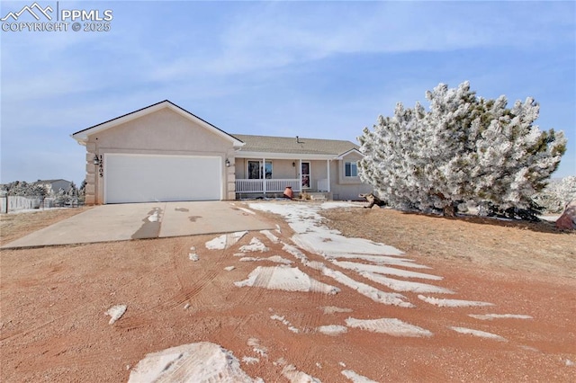 single story home with driveway, an attached garage, and stucco siding