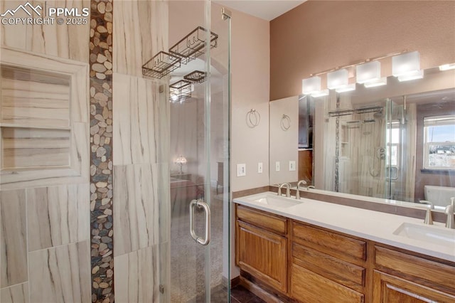 full bathroom with a stall shower, a sink, and double vanity