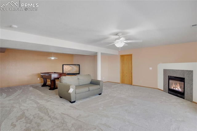 living room with visible vents, baseboards, light colored carpet, and a glass covered fireplace