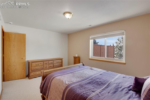 carpeted bedroom featuring visible vents