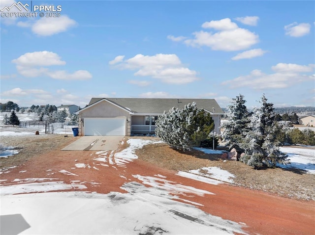 view of front of property featuring driveway, an attached garage, and stucco siding