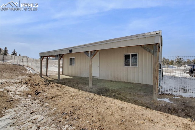 rear view of property featuring fence