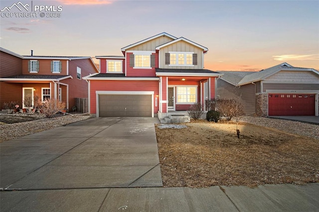 traditional home featuring an attached garage, board and batten siding, and concrete driveway