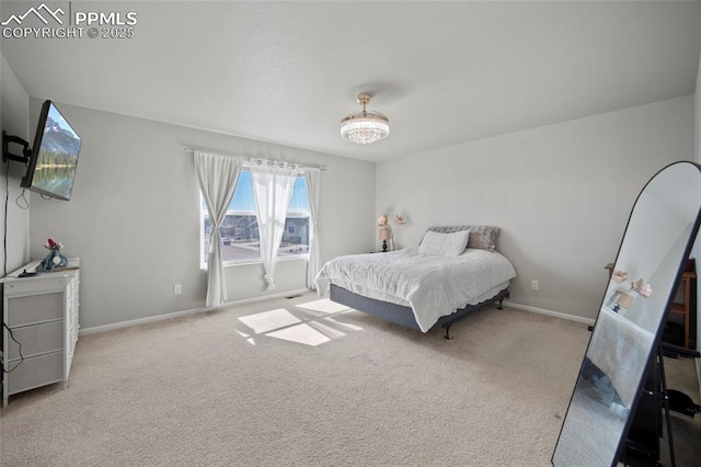 carpeted bedroom featuring baseboards