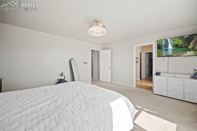 bedroom featuring light carpet and baseboards